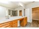 Bright bathroom featuring double sinks, quartz counters, tile shower and walk-in closet at 245 Astoria Way, Mcdonough, GA 30253