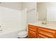 Well-lit bathroom featuring a tub with shower and a wooden vanity at 245 Astoria Way, Mcdonough, GA 30253