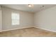 Comfortable bedroom featuring soft carpet, neutral walls, and ample natural light at 245 Astoria Way, Mcdonough, GA 30253