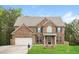 Charming two-story brick home featuring a well-manicured lawn and an attached two-car garage at 245 Astoria Way, Mcdonough, GA 30253