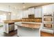 Bright kitchen featuring granite countertops, stainless steel appliances, and a functional center island at 245 Astoria Way, Mcdonough, GA 30253