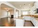 Open-concept kitchen featuring granite countertops, stainless steel appliances, and breakfast bar to living room at 245 Astoria Way, Mcdonough, GA 30253
