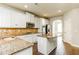 Modern kitchen with white cabinets, granite countertops, stainless steel appliances and a center island at 245 Astoria Way, Mcdonough, GA 30253