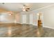 Open living space with hardwood-style flooring, neutral paint, and ceiling fans for a bright and airy feel at 245 Astoria Way, Mcdonough, GA 30253