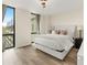 Bright bedroom with hardwood floors, a large window, and a comfortable queen-sized bed at 2870 Pharr Court South Nw # 504, Atlanta, GA 30305