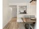Dining room with wood floors and a view into the kitchen through a pass-through window at 2870 Pharr Court South Nw # 504, Atlanta, GA 30305