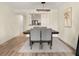 Dining room with wood floors, a modern chandelier, and a pass-through window into the kitchen at 2870 Pharr Court South Nw # 504, Atlanta, GA 30305