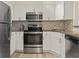 Well-lit kitchen featuring white cabinets, stainless steel appliances, and granite countertops at 2870 Pharr Court South Nw # 504, Atlanta, GA 30305