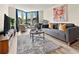 Comfortable living room featuring a gray sofa, swivel chairs, and a round coffee table at 2870 Pharr Court South Nw # 504, Atlanta, GA 30305