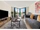 Bright living room with modern furnishings, large windows, and a cozy seating area at 2870 Pharr Court South Nw # 504, Atlanta, GA 30305