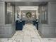 Inviting lobby with elegant seating area with plush blue chairs, decorative mirror, marble floors, and decorative pillars at 2870 Pharr Court South Nw # 504, Atlanta, GA 30305