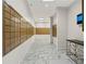 Bright mailroom featuring a long wall of mailboxes and marble floors, and an electronic package locker at 2870 Pharr Court South Nw # 504, Atlanta, GA 30305