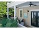 Inviting covered balcony with ceiling fans, comfortable seating, and charming decor, perfect for relaxation at 4124 Hunt St, Covington, GA 30014