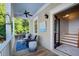 Cozy balcony with outdoor seating, blue patterned rug, and access to the home's interior staircase at 4124 Hunt St, Covington, GA 30014