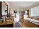 Well-lit bathroom boasts double vanity with granite counters, a shower, and a soaking tub at 4124 Hunt St, Covington, GA 30014