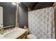 Stylish bathroom with a unique vanity, black walls, and modern fixtures at 4124 Hunt St, Covington, GA 30014
