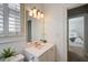 Bright bathroom with white vanity, plantation shutters and view into the bedroom at 4124 Hunt St, Covington, GA 30014
