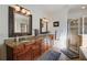 Bathroom features a double vanity with granite counters, a shower with glass door, and tile floors at 4124 Hunt St, Covington, GA 30014
