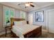 Bedroom with a wood bed frame, neutral decor, carpet flooring, and shuttered windows at 4124 Hunt St, Covington, GA 30014