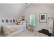 Bright, minimalist bedroom with unique artwork, soft carpet, and a cozy reading corner at 4124 Hunt St, Covington, GA 30014