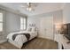 Bright bedroom boasts a neutral palette, carpet flooring, and a double-door closet at 4124 Hunt St, Covington, GA 30014