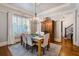 Sunlit dining room with hardwood floors, large window, and decorative lighting at 4124 Hunt St, Covington, GA 30014