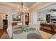 Open concept dining room with views of the living room and modern light fixture at 4124 Hunt St, Covington, GA 30014