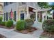 Landscaped walkway leading to the front entrance, showcasing manicured bushes and a charming white gate with pergola at 4124 Hunt St, Covington, GA 30014