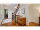 Grand foyer showcasing hardwood floors, staircase with iron balusters, and decorative chest at 4124 Hunt St, Covington, GA 30014