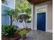 Charming home featuring a welcoming blue front door, decorative plants, and stone tile porch at 4124 Hunt St, Covington, GA 30014