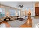 Spacious living room with fireplace, hardwood floors, and abundant natural light at 4124 Hunt St, Covington, GA 30014
