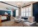 Spacious main bedroom showcases a blue accent wall, sitting area, and large windows at 4124 Hunt St, Covington, GA 30014