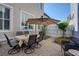 Cozy outdoor patio featuring a dining table with umbrella, chairs, and access to a garden at 4124 Hunt St, Covington, GA 30014