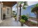Charming outdoor patio with stone flooring, tropical plants, and a decorative water fountain near the entrance at 4124 Hunt St, Covington, GA 30014
