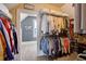 Well-organized walk-in closet with dual-hanging rods and shelving units with view of office beyond at 4124 Hunt St, Covington, GA 30014