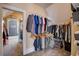 Well-organized walk-in closet with dual-hanging rods and shelving units with view of office beyond at 4124 Hunt St, Covington, GA 30014