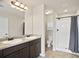 Bright bathroom featuring a dual sink vanity, walk in shower, tile floors and neutral colors at 4133 Shoals Ln, Union City, GA 30291