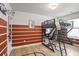 Bedroom featuring brown and white striped walls, wood floors, and a loft bed with workspace underneath at 4133 Shoals Ln, Union City, GA 30291