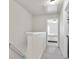 Bright hallway with gray carpeting leading to a bedroom featuring a white ceiling and access to additional rooms at 4133 Shoals Ln, Union City, GA 30291