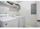 Clean laundry room equipped with white washer and dryer, shelving for storage and easy access to laundry at 4133 Shoals Ln, Union City, GA 30291