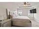 Luxurious main bedroom featuring a tray ceiling, plush carpet, and an elegant accent wall at 4133 Shoals Ln, Union City, GA 30291