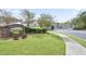 Beautiful community entrance with lush landscaping, green grass, sidewalk, and street at 4133 Shoals Ln, Union City, GA 30291