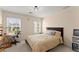 Bright bedroom with a bed, a desk, two large windows and carpeted floors at 847 Edgeley Ln, Lawrenceville, GA 30044