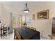 Dining room with large table, gray tiled floors, double doors, and traditional light fixture at 847 Edgeley Ln, Lawrenceville, GA 30044
