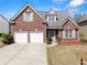 Charming brick home featuring a two-car garage, well-manicured lawn, and inviting entryway at 847 Edgeley Ln, Lawrenceville, GA 30044