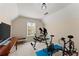 Bright, upper level home gym with an exercise machine, weights and a flat screen television at 847 Edgeley Ln, Lawrenceville, GA 30044