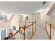 Upstairs hallway with chandelier lighting, neutral walls, wood trim and carpeted floors at 847 Edgeley Ln, Lawrenceville, GA 30044