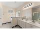 Main bathroom with dual sinks, walk-in shower, and tub with white backsplash at 847 Edgeley Ln, Lawrenceville, GA 30044