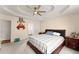Spacious bedroom featuring tray ceiling, plush carpet, and dresser with mirror at 847 Edgeley Ln, Lawrenceville, GA 30044