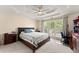 Spacious bedroom featuring tray ceiling, plush carpet, and large window at 847 Edgeley Ln, Lawrenceville, GA 30044